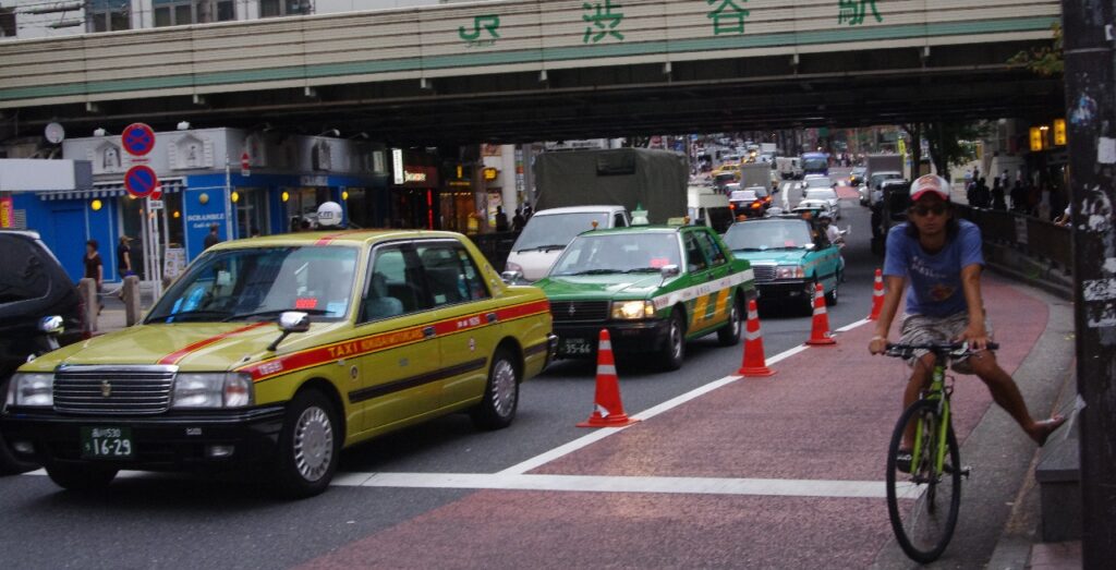 Japanese Taxis waiting at the traffic light.